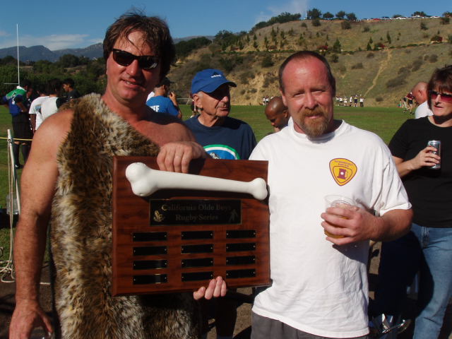 A Fossil holds the California Olde Boys Rugby Series bone plaque